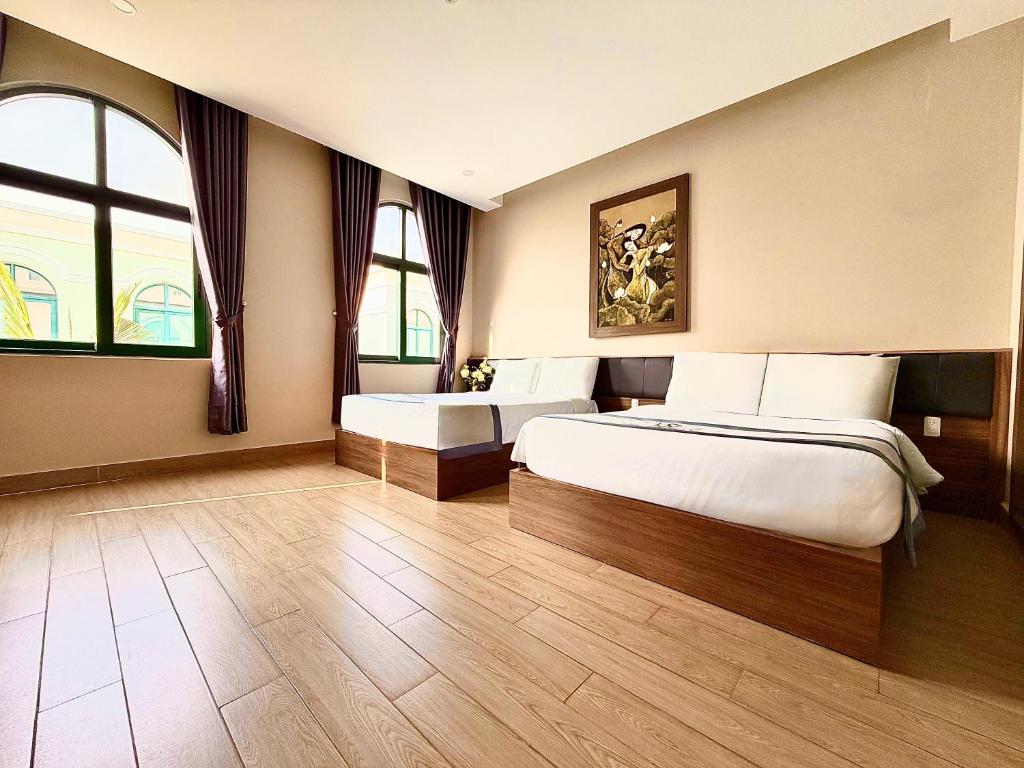 a hotel room with a bed and a window at My Marina Beach Hotel Phu Quoc in Phú Quốc