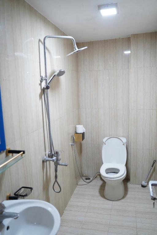 a bathroom with a shower and a toilet and a sink at Su Ha Giang Hostel in Ha Giang