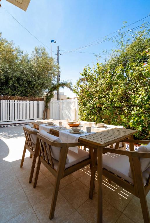 a wooden table and chairs on a patio at Casa dos mares in San Javier
