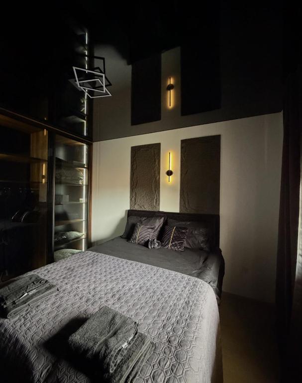 a bedroom with a bed in a dark room at Nanna apartman in Ruma