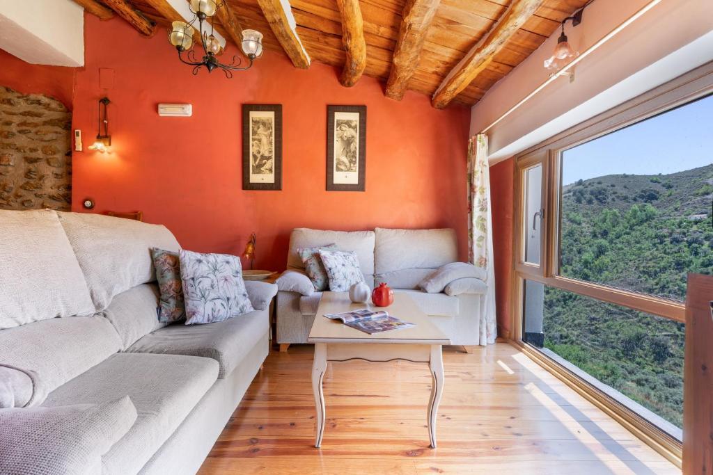 a living room with a couch and a table at Casa Alfurán in Alfornón