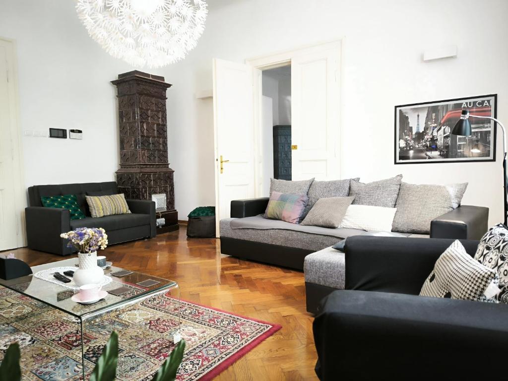 a living room with a couch and a table at Konzul -Top apartment, strict center, parking in Osijek