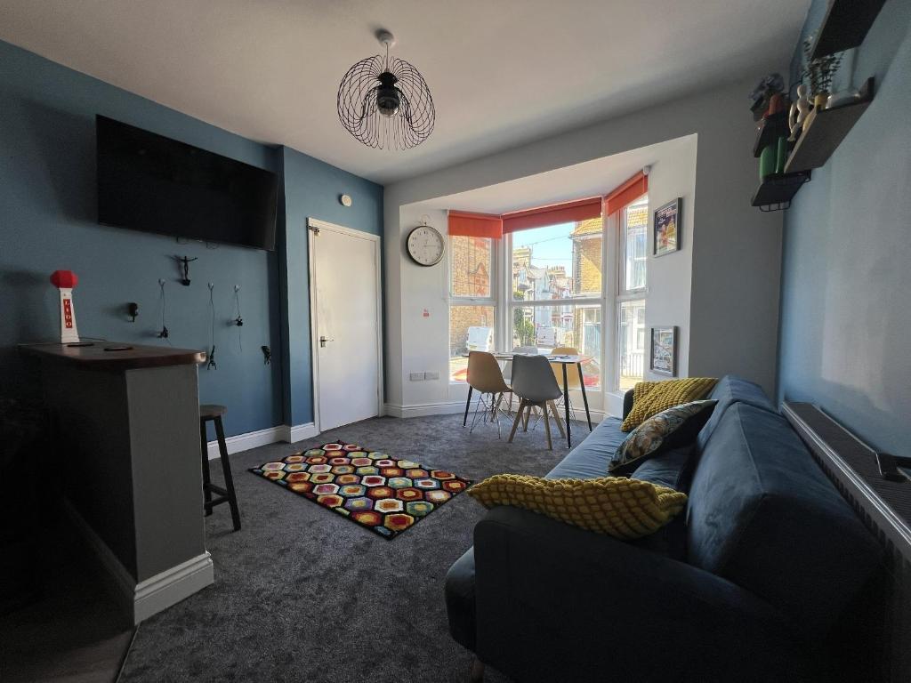 a living room with a couch and a table at Full Apartment in the Heart of Margate in Margate