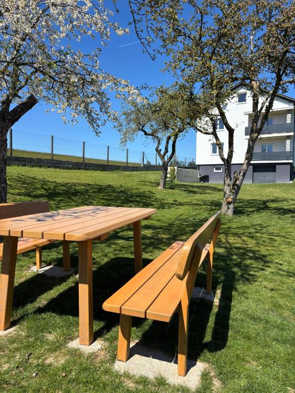 a wooden picnic table and bench in a park at Mühlviertler Auszeit in Pisling