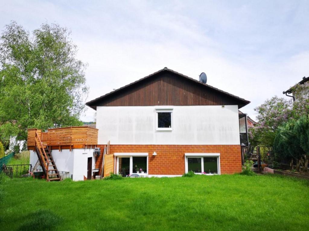 a house with a brown and white at Haus Birkenblick in Rimbach
