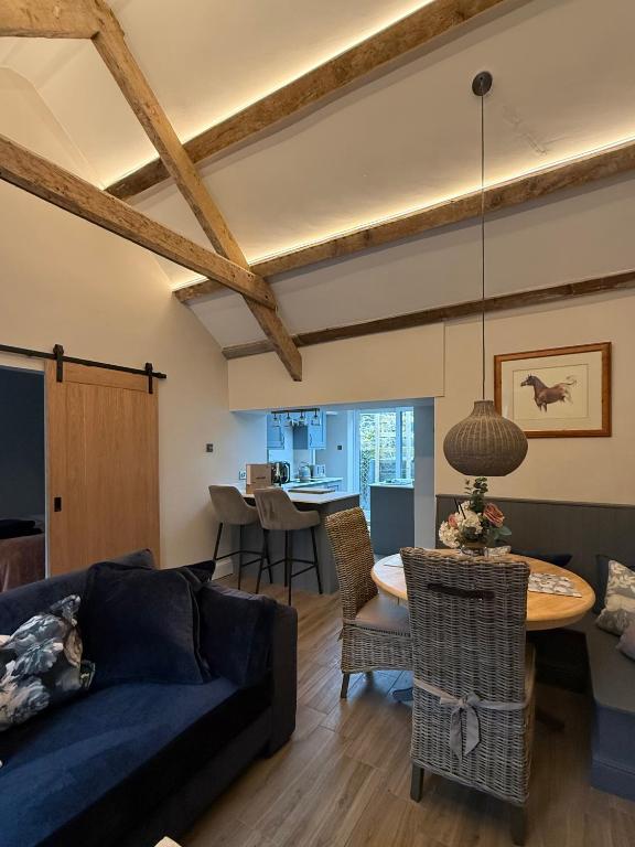 a living room with a couch and a table at Sandytoes Cottage in Pentraeth