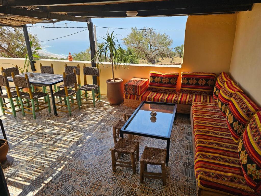 a living room with a couch and a table at Superbo Stay Sea View Surf House near Taghazout Panoramic Terrace in Taghazout