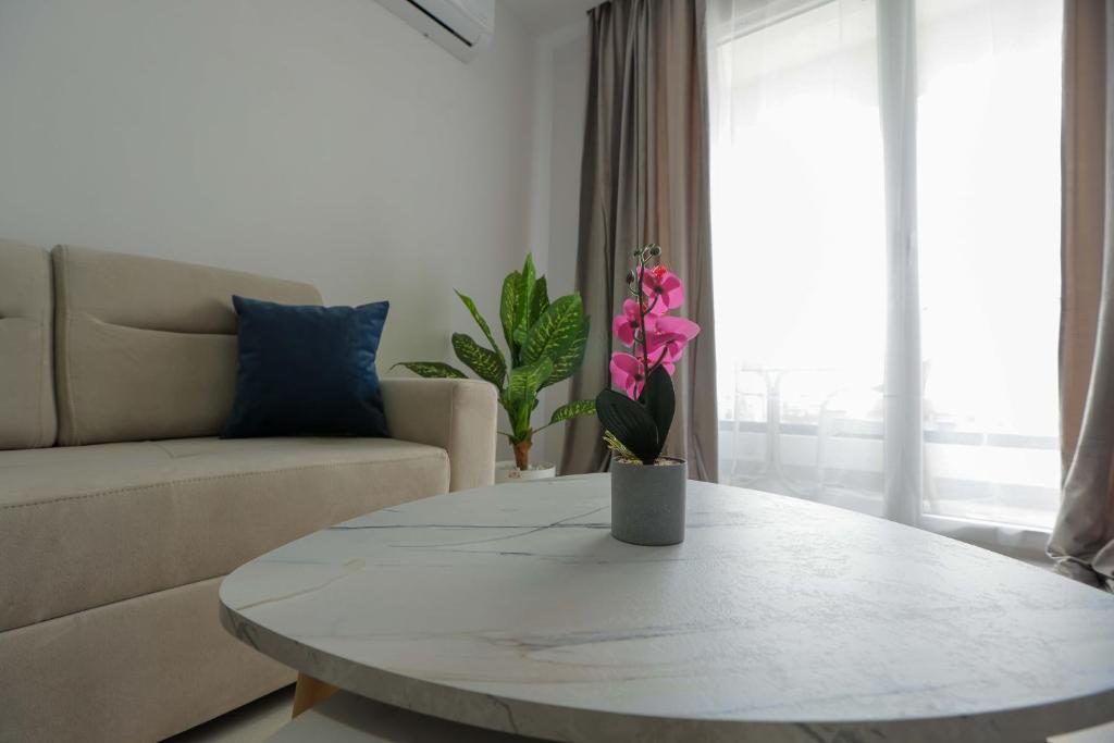 a living room with a table and a couch at Crown Apartments in Golem