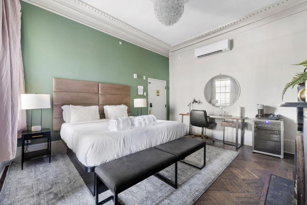 a bedroom with a large bed and a desk at King Suite 2nd FloorHotel Boutique in Savannah