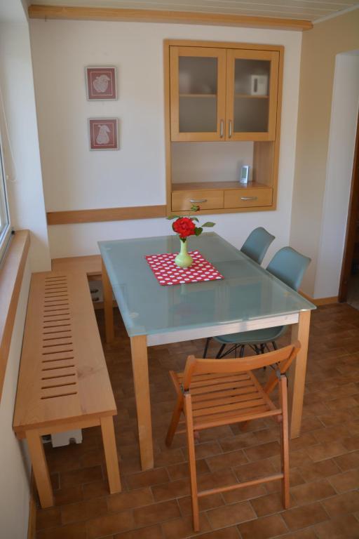 a table and chairs with a vase of flowers on it at Apartmaji Grapa in Most na Soči