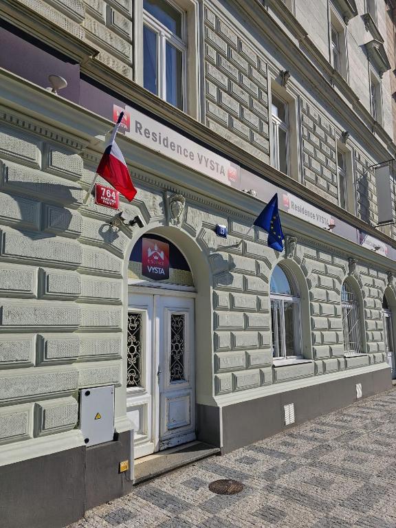 a facade of a building with flags on it at Residence Vysta in Prague