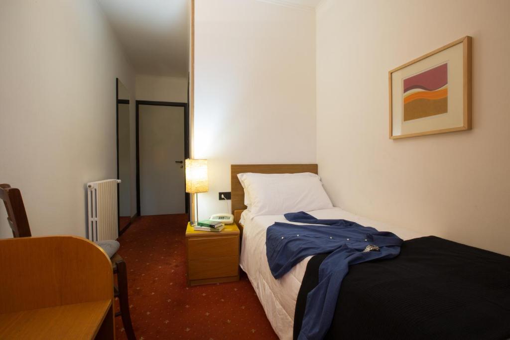 Postel nebo postele na pokoji v ubytování Albergo Giardino