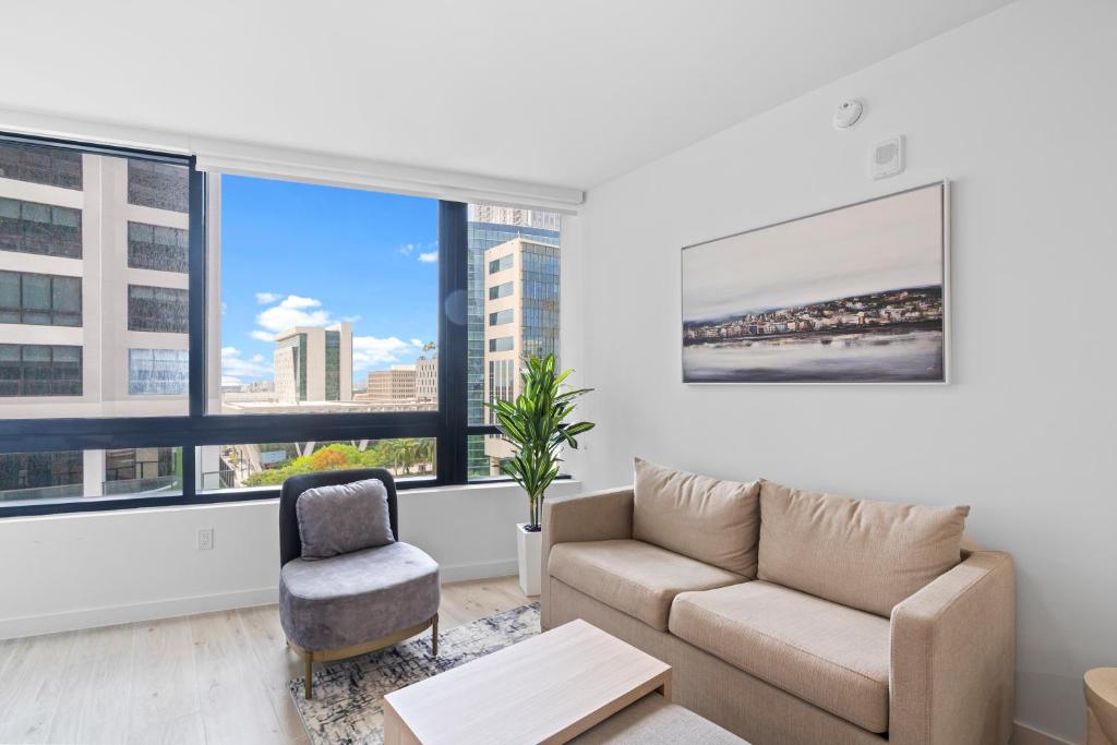 a living room with a couch and a chair at Downtown Miami Condo w Pool & Great Location in Miami