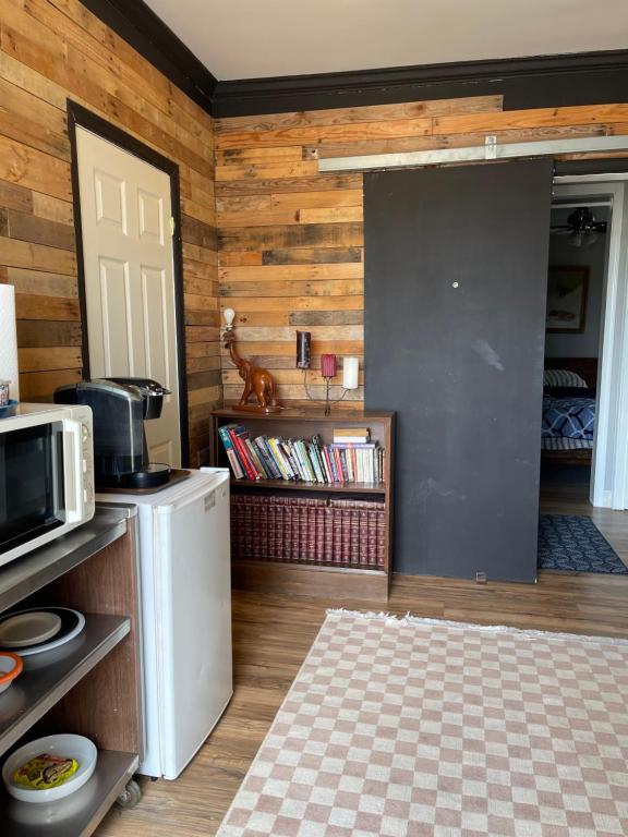a kitchen with wooden walls and a door and a microwave at Flower Avenue Hosting - Private Suite with De Luxe King Size Bed - 77 per Night 1st guest - 59 2nd guest - 52 each third & 4th guests in Silver Spring