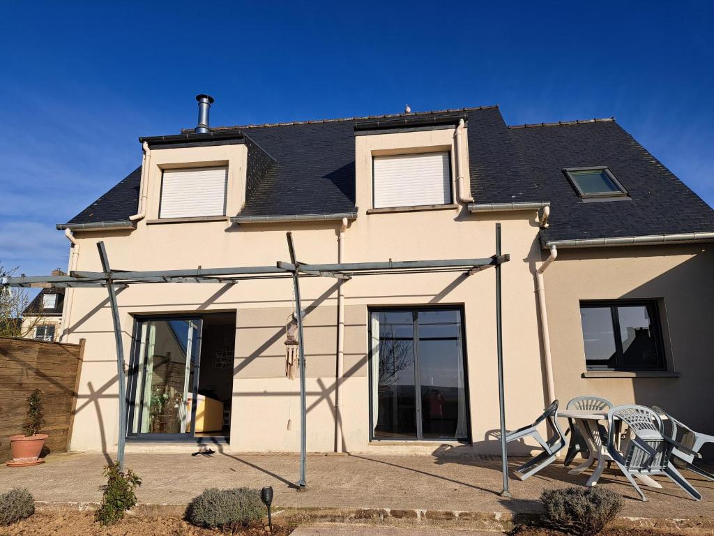 a house with two chairs in front of it at Ker valou in Hénansal