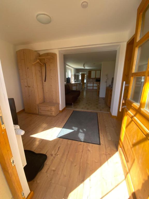 a room with a door and a rug on a wooden floor at M1 Appartement in Uttenweiler