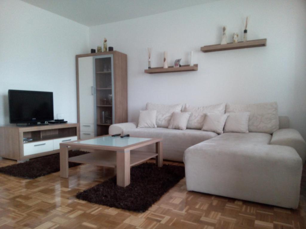 a living room with a couch and a coffee table at Apartment Condor in Tuzla
