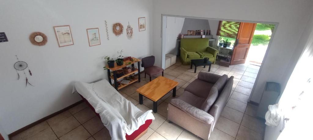 a living room with a couch and a table at ASLANA Hostel in Mar del Plata