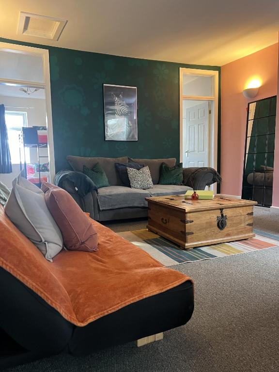 a living room with a couch and a coffee table at The Hive 2-Bed Apartment with Kitchen and Private Bathroom in Lively Monton Village - Sleeps 4 - Free WiFi - Parking Nearby in Manchester