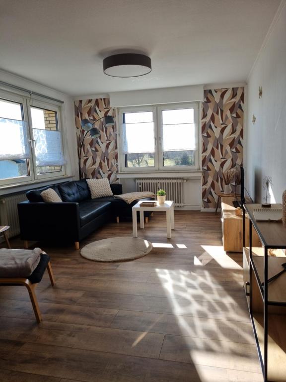 a living room with a couch and a table at Ferienwohnung Am Brombachtal in Simmerath