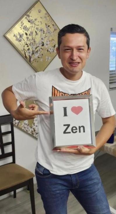 a man holding a sign that says i love zen at Zen Hostel - Women Only Dorm - Men Only Dorm - Under New Management in Fort Lauderdale