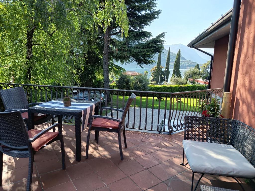 a patio with a table and chairs and a fence at Villa Leilani B&B in Sale Marasino