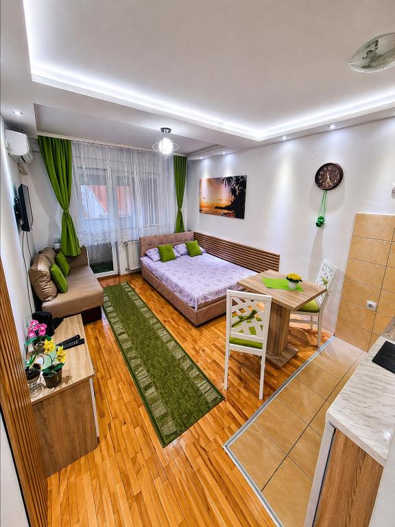 a living room with a couch and a table at ZVEZDA LUX in Kruševac