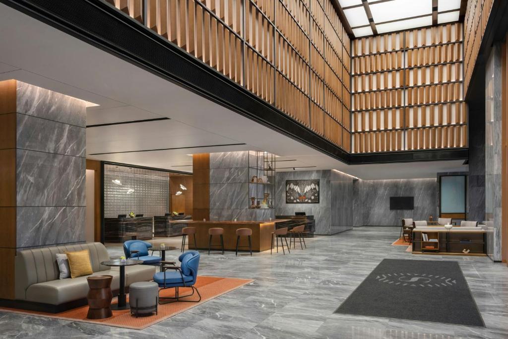 a rendering of a lobby with chairs and tables at Sheraton Kota Kinabalu in Kota Kinabalu