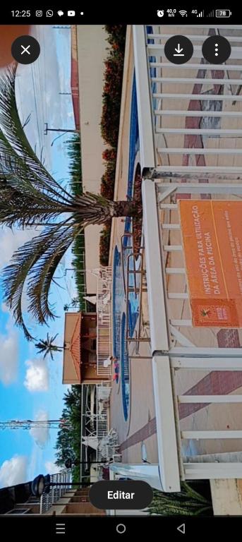 a view of a building with a palm tree next to it at Âncora Horto da barra in Barra dos Coqueiros