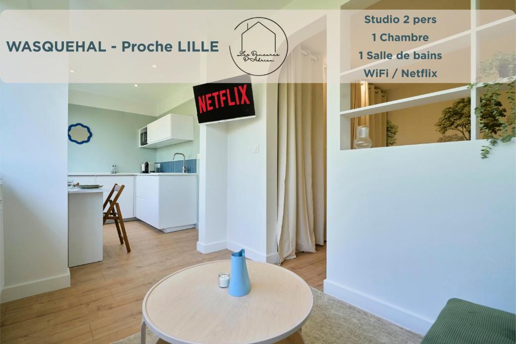 a kitchen and a living room with a table at Le Nid - Parking - 15 min centre de Lille in Wasquehal