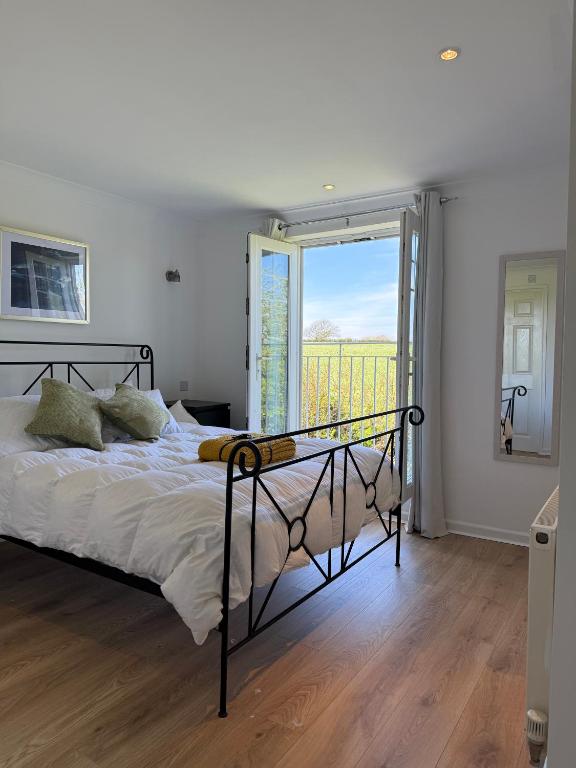 a bedroom with a bed and a large window at Seashells in Newquay