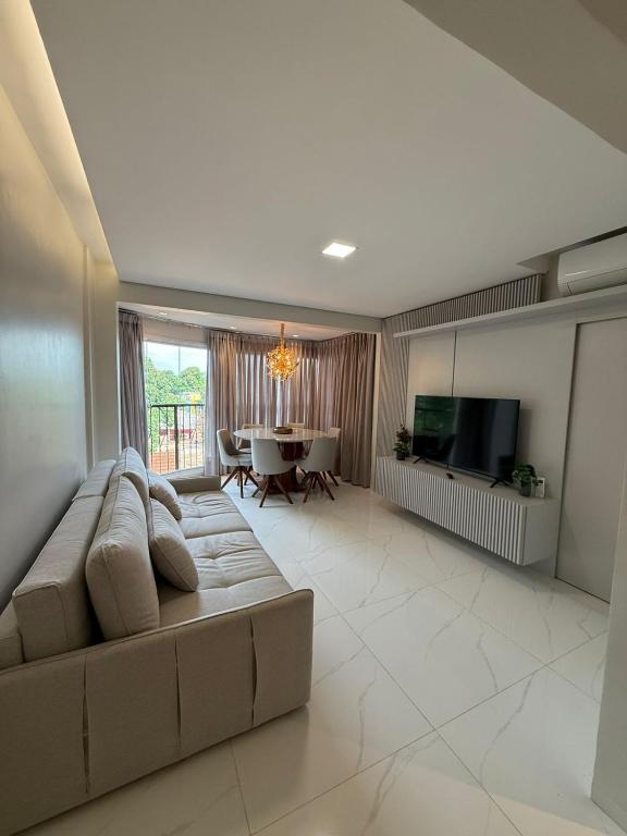 a large living room with a couch and a television at Charming Apartment in the Central Square in Bonito