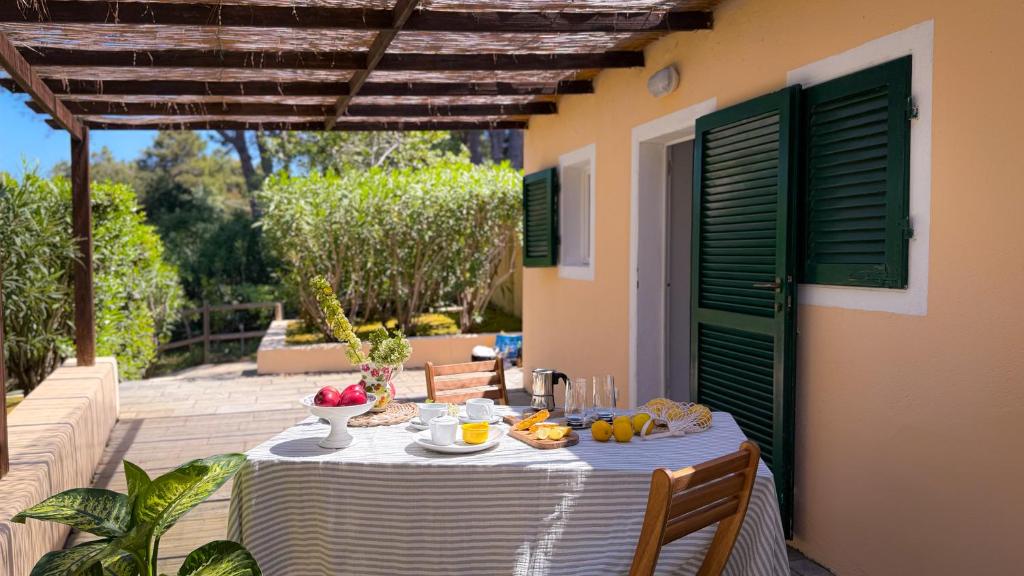 a table with a bowl of fruit on a patio at Orizzonte Blu - HelloElba in Marciana Marina