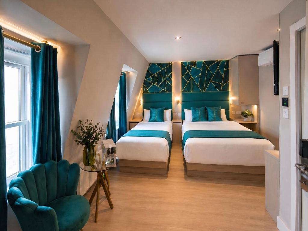 a hotel room with two beds and a chair at Seven Paddington in London