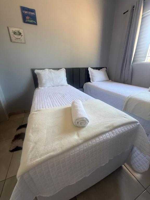 two beds sitting next to each other in a room at Amazon Loft 09 in Sorriso