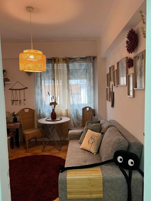 a living room with a couch and a table at Camurichico in Figueira da Foz