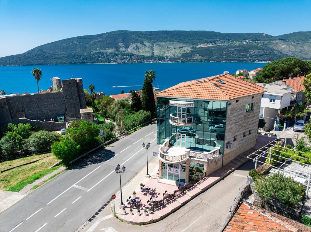 a building on the side of a street next to a road at Castello Mare Residence in Herceg-Novi