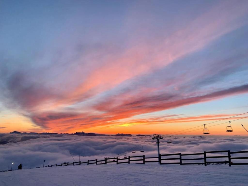 a view of a ski lift in the snow at sunset at studio Nivéole 303 in Chamrousse