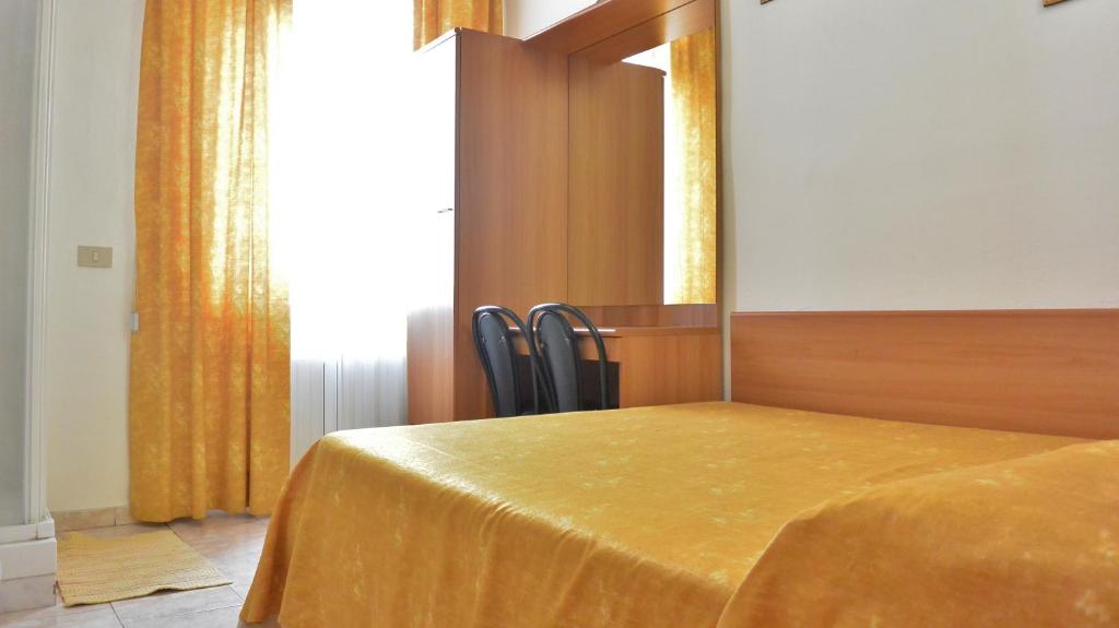 Postel nebo postele na pokoji v ubytování Hotel Mignon