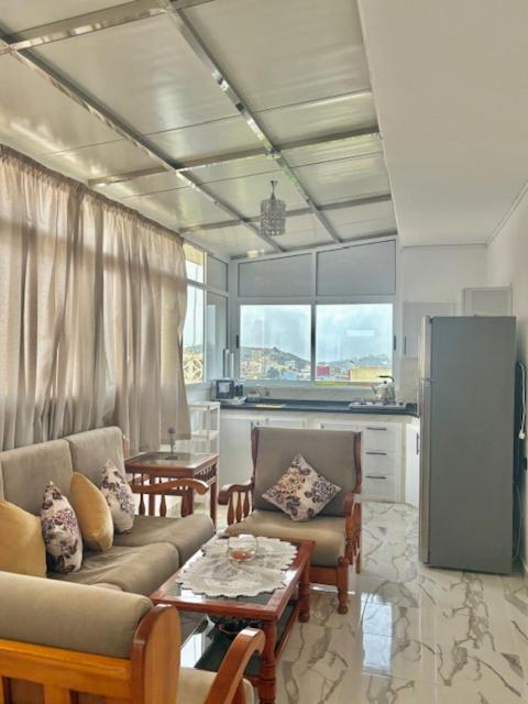 a living room with a couch and a table at Appartement Ajdir in Al Hoceïma