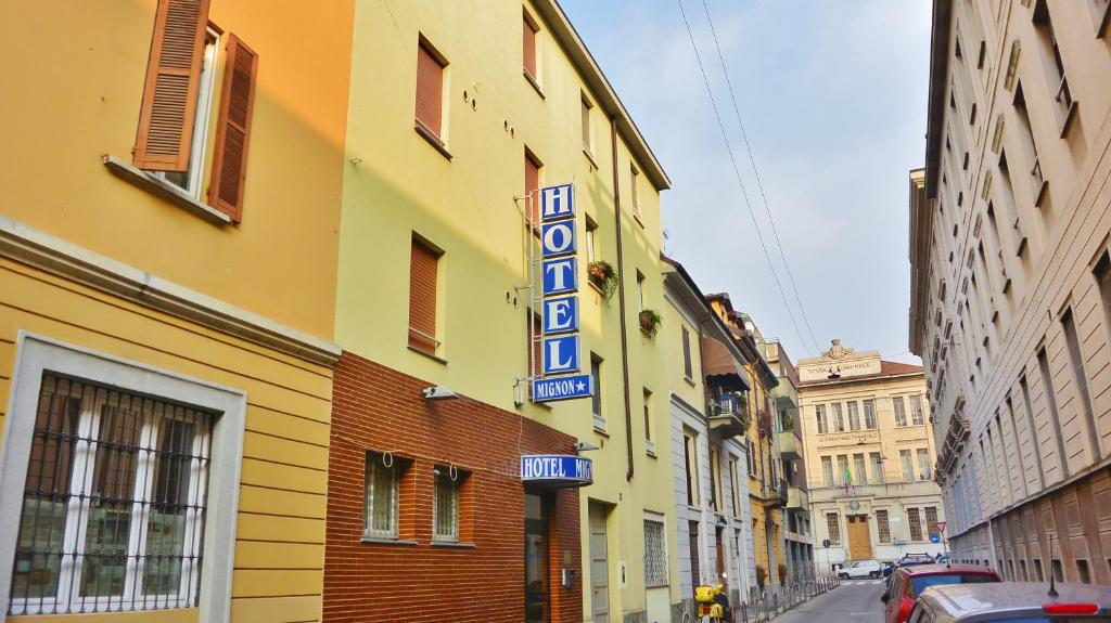 a hotel sign on the side of a building at Hotel Mignon in Milan