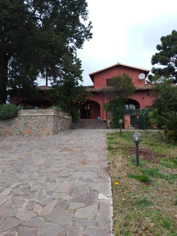 a house with a stone driveway in front of it at Casa Daniela in Velletri