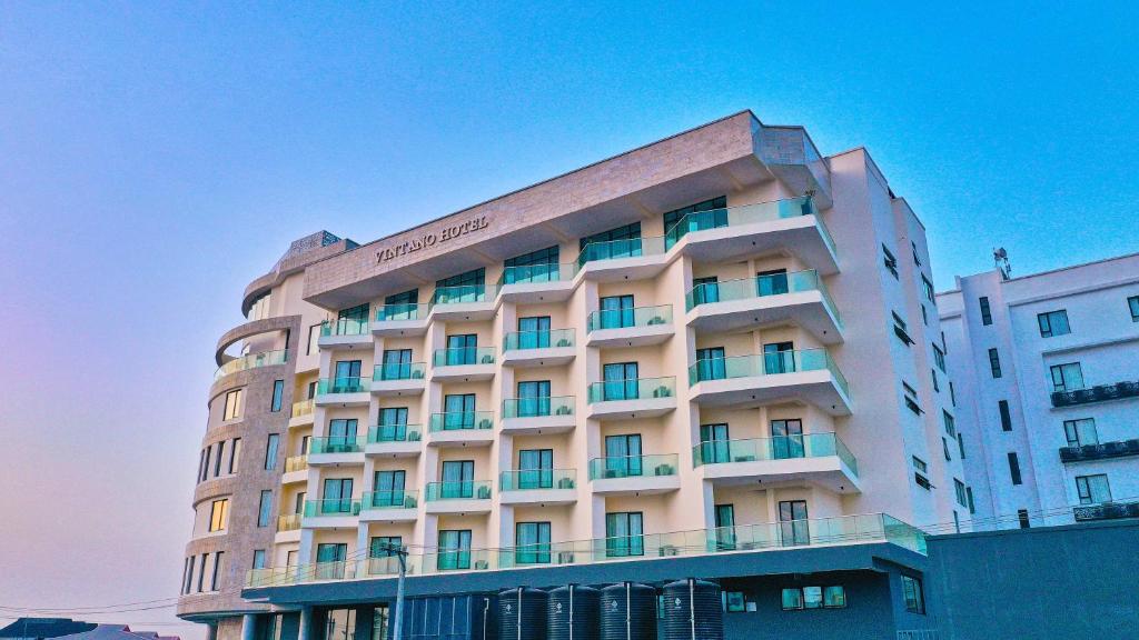 a hotel building with a sign on top of it at Vintano Hotel in Lagos