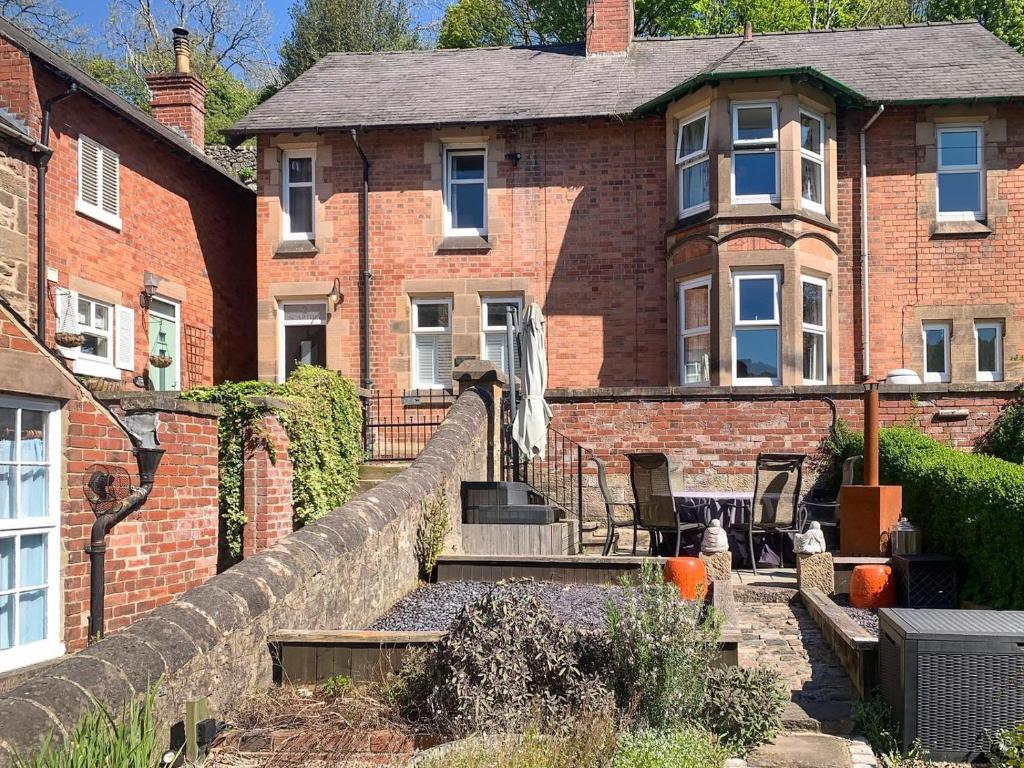 a brick house with a staircase in front of it at 3 Bed in Cromford oc-t30751 in Cromford