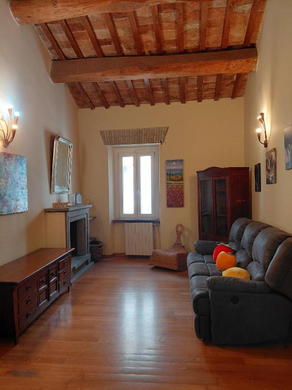 a living room with a couch and a fireplace at Berny House in Bracciano