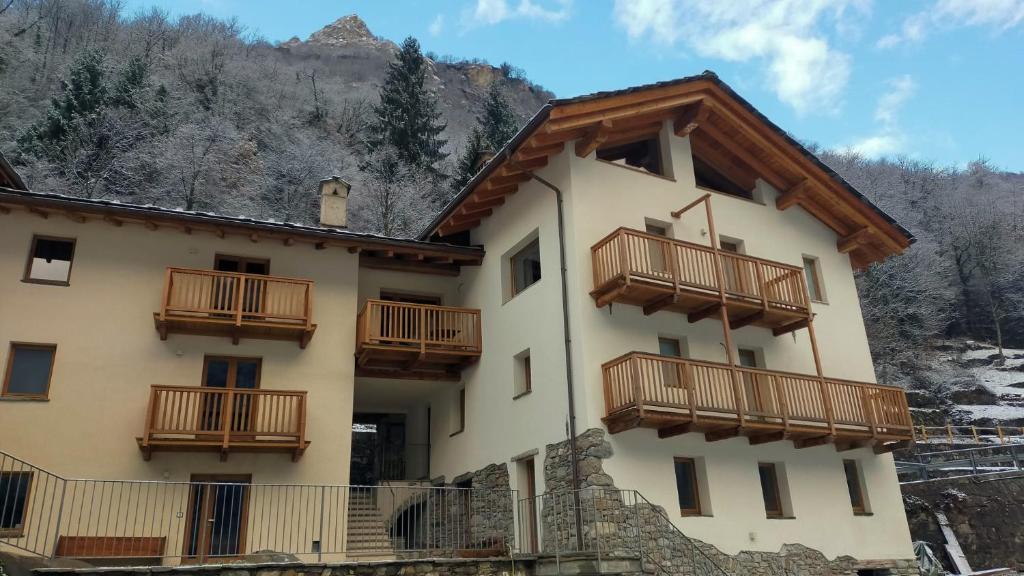 a building with wooden balconies on the side of it at B&B Court1828 in Lillianes
