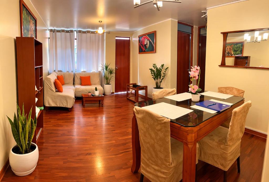a living room with a table and a couch at Departamento Privado in Lima