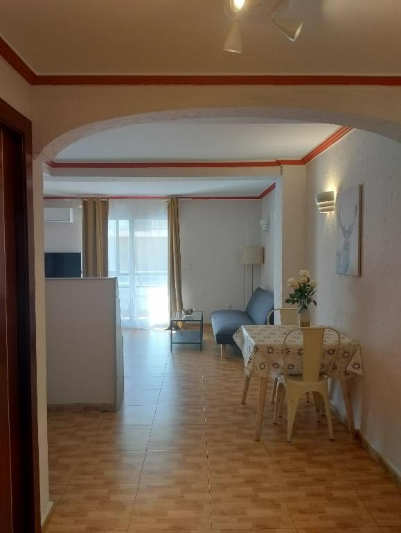 a living room with a table and a couch at Unique Apartahotel 2-2 in Torrevieja
