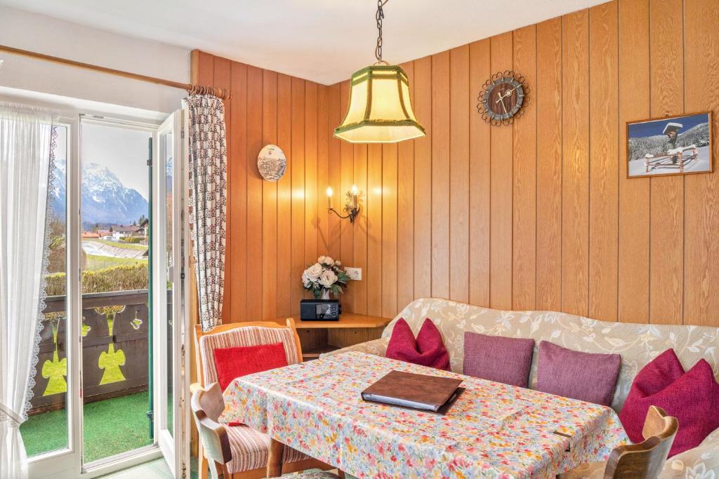 a living room with a table and a couch at Ferienwohnung 1 in Wallgau