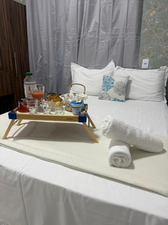 a bed with a tray of food and towels on it at Amazon loft 03 in Sorriso